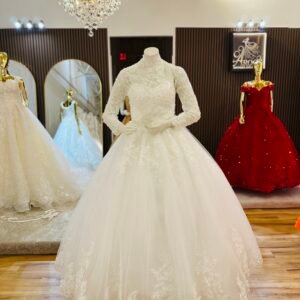 Bridal ball gown features strapless neckline layered under a delicate high-neck lace top adorned with intricate floral stitching